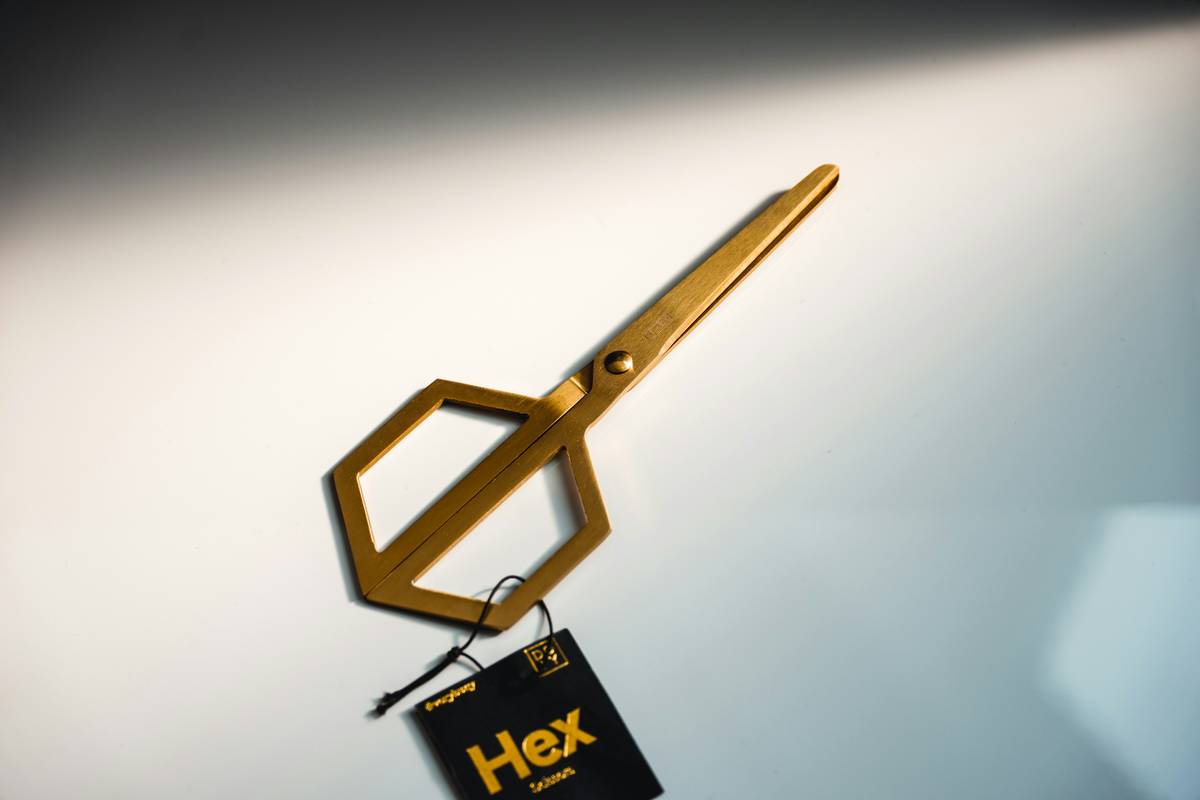 Assorted hex climbing accessory pieces compared to modern cams on a climbing rack
