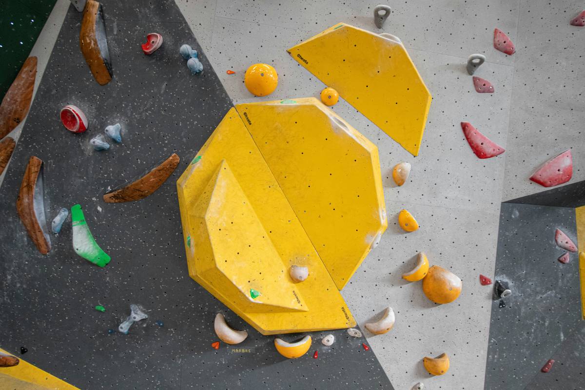 Climber placing a hex climbing accessory in a flared granite crack