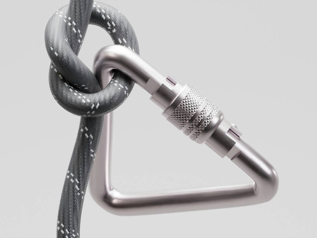 hex climbing ring placed in a flared granite crack during a multi-pitch ascent
